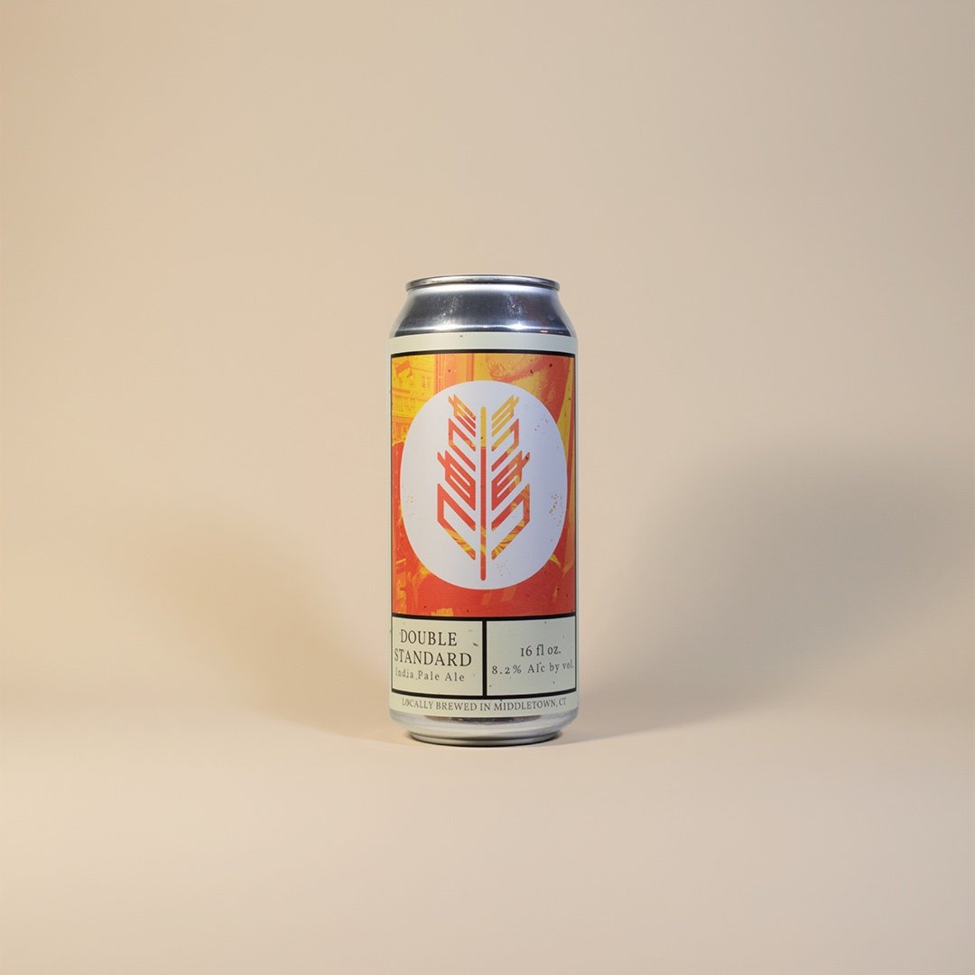 Studio product shot of Double Standard, an 8.2% India Pale Ale, shot on a warm seamless backdrop.