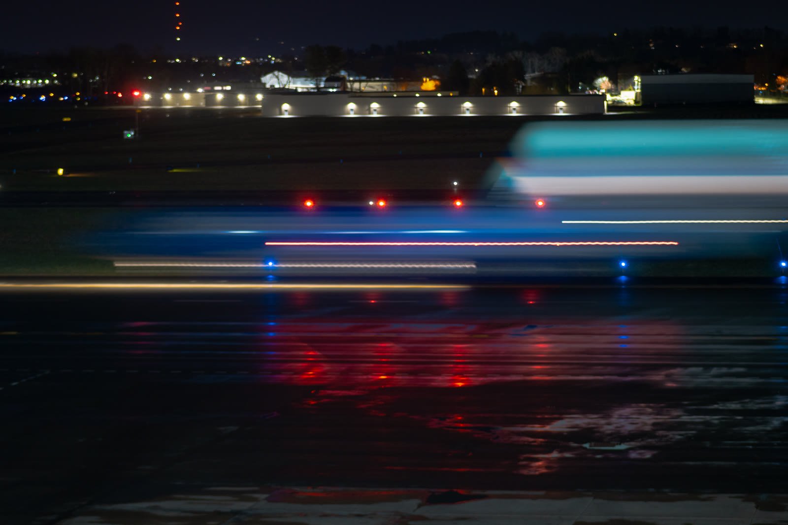 From "Time Flies," a long-exposure motion blur of a plane at night.