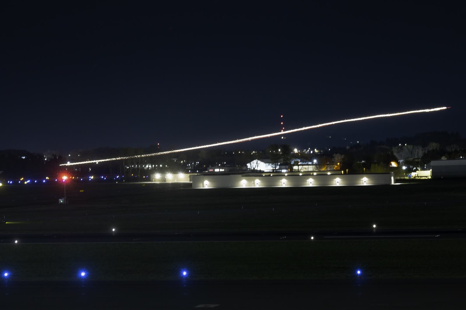 From "Time Flies," a long-exposure night shot of a plane departing the runway.